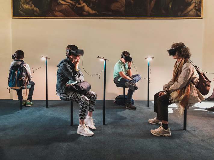 Close-up of various VR controllers including Oculus Touch, Valve Index, and PS VR2 Sense arranged neatly on a dark gaming desk